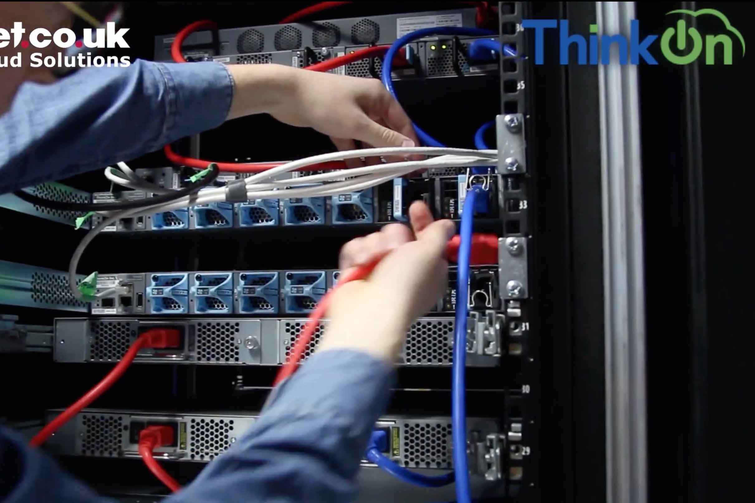 a close up of staff menber's hands as they plugin and install servers into thinkon's rack sapce